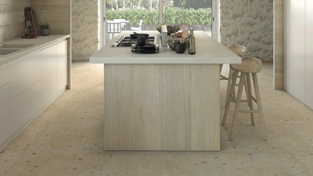 Neutral coloured kitchen with island and terrazzo effect porcelain floor